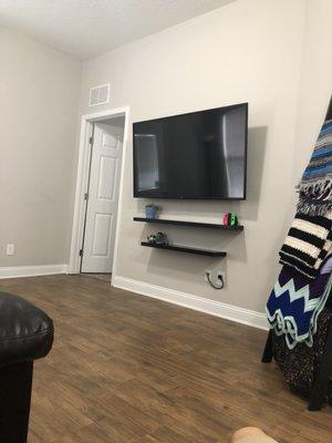 Mounted TV, floating shelves, and best of all no crazy wires.