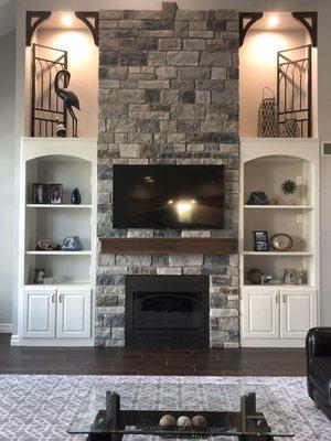 Bye-bye honey oak fireplace & built-ins. Hello stonework, custom mantel, painted cabinets & more!