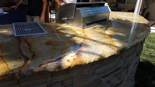 Outdoor BBQ concrete top with natural rock edge