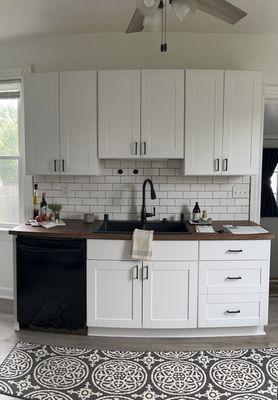 Small kitchenette install. Plumbing, plumbing fixtures, light fixtures, tile, flooring, appliance fitting, sink set in, counter install.