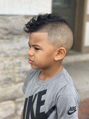 He wanted more of a "Mohawk" cut so he made it work with the hair he had  he loved it!