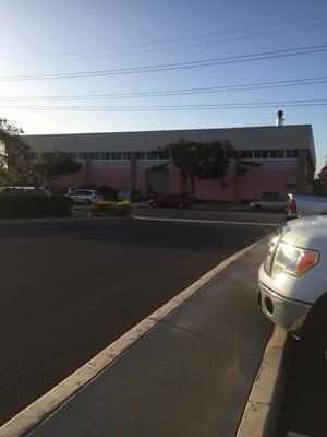 When you see the pink Hawaii Coffee building, you have arrived! It's right across the street!