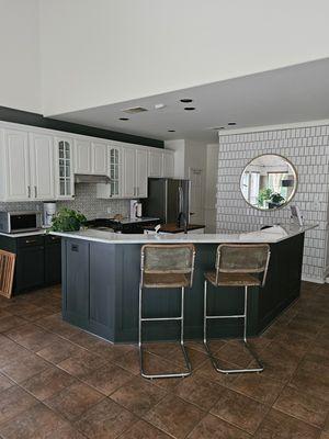 Kitchen cabinets painted white and walls painted a darker color.