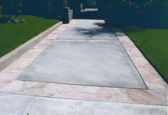 Concrete driveway with flagstone ribbons.