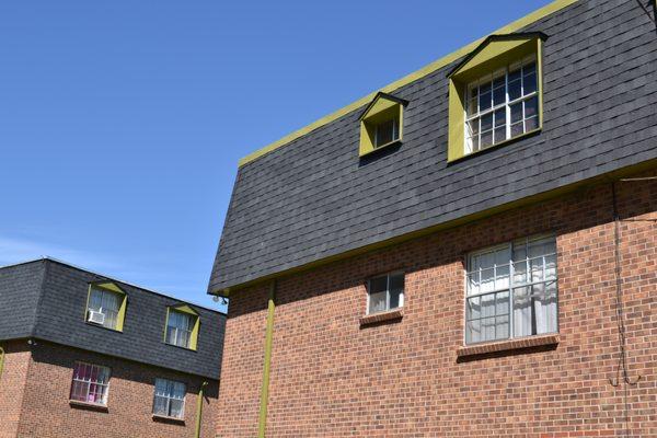 Replaced cedar shake mansards with asphalt shingles