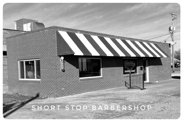 Local Barbershop located at 1102 Kansas Avenue next to Bayless Dry Cleaning.