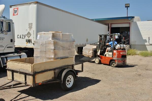 Loading pallets in my trailer for the last five miles of their journey.