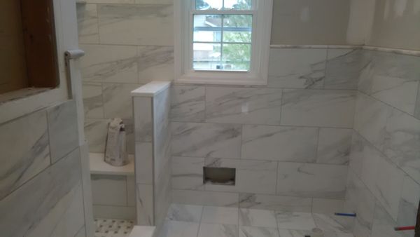 Removed a tub, installed   a mud shower with 12"x24" porcelain tile w/ matched grain