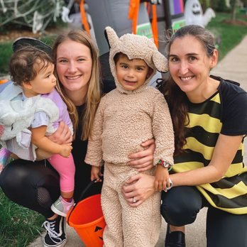 Laura, a German au pair, has her arms full with these two little trick or treaters!