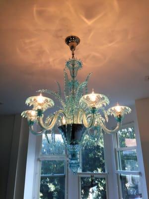 A BEAUTIFUL Murano glass chandelier assembled and installed (very carefully) by Ike's.