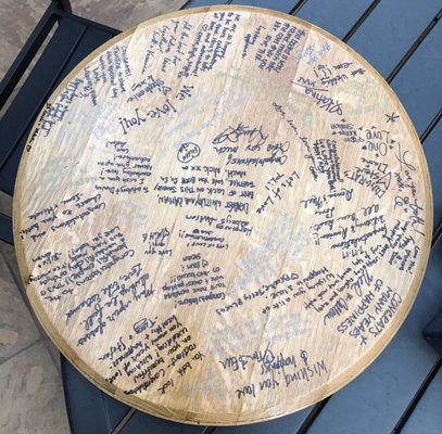 Wine barrel top used as a guest book at wedding