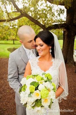 A couple just married at The Oaks at Salem in Apex, NC. Green and ivory floral bouquet by Brides and Bouquets.