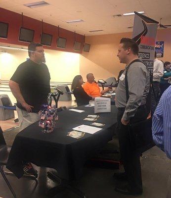 Our Director of Technology speaking with a guest at a Chamber of Commerce event