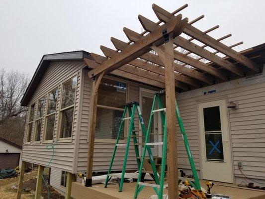 Four season porch addition with pergola covered outdoor space