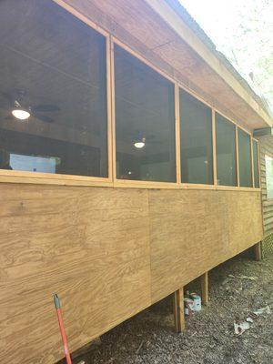 Newly screened in and stained exterior of the screened in porch living space.