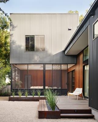 Abbenante Residence: Aggregate patio with custom wood bench and steel planters. Photo Credit: Caseydunn.net