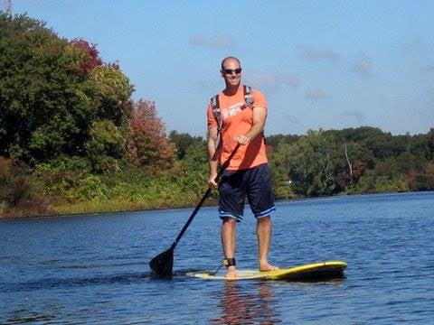 Koko Needham/Sudbury Owner, Paul R, on the Charles river during a Koko Adventure Team Kayak/Paddleboard journey..