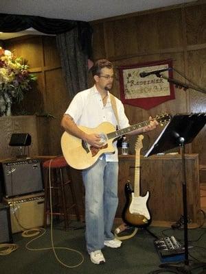 Pastor David Playing Guitar