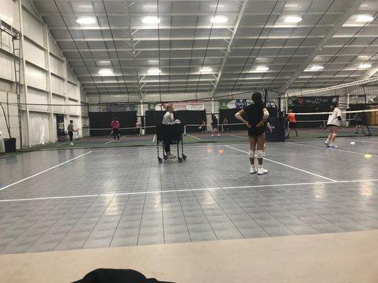 Volleyball in front, pickle ball in the background