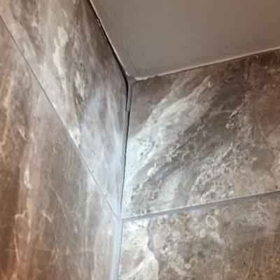 Example 2nd Floor Hall Bathroom Cracked Grout  between the Shower Wall and Ceiling