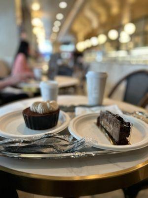 Chocolate Noir & Tiramisu (Behind) small chai latte w/ oat milk, medium honey hazelnut late w/ oat milk