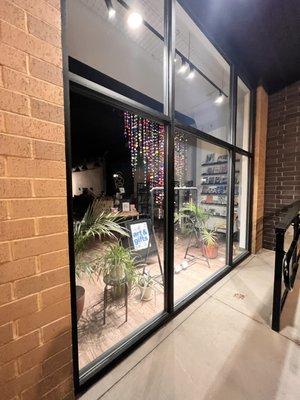 View of Rose and Eugene's store front at night.