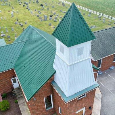 Green custom metal roof supplied by Ridgetop Roofing