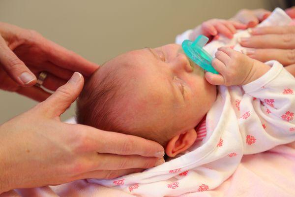 Baby Emma get her first adjustment at a few weeks old.