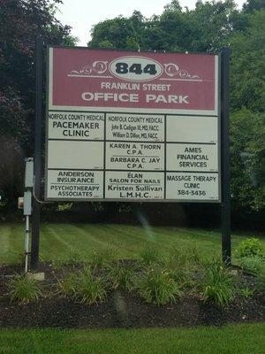 Landmark: Turn into the driveway at this sign, then park in the rear of the building.