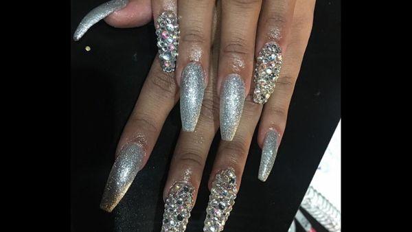 Silver gel polish with crystal nails to top the look off .