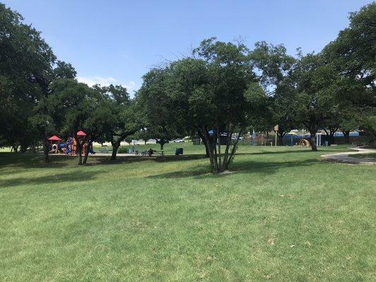 View from parking lot: Playground on left, splash pad on right