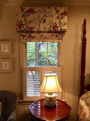 Roman shades with valances over café shutters