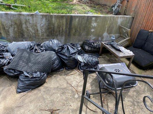 all the bags of yard debris that got rained  on, wet and nasty. old rusty grill