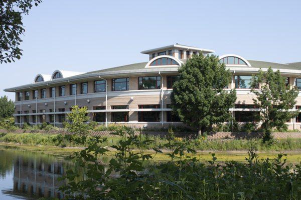 View of the southeast curve of the building, across the pond.