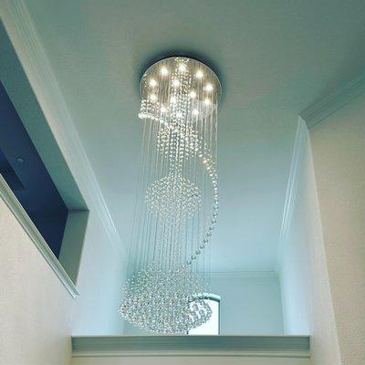 Install high ceiling chandelier