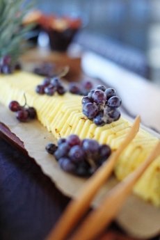 A fresh fruit platter displayed on wood.