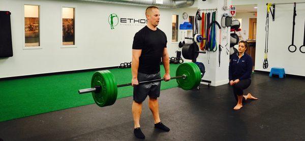 John developing total body strength during his conventional deadlifts in his personal training session with Coach Jess