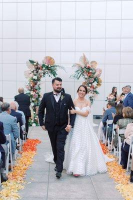 Custom chuppah and ombre rose petals down the isle