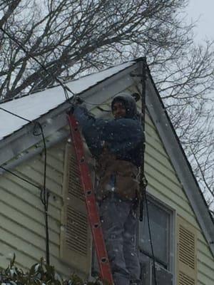 Mr. Avila taking care of his customers during a snowy day.