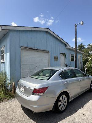 Exterior view of Palmetto Sewing Center. There is a small sign behind the entrance door .