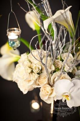 Centerpieces with imagination, suspending votives, white phalenopsis orhids, calla lilies and spray roses