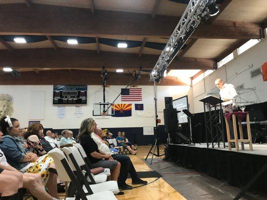 Sunday worship inside the gymnasium of Pusch Ridge Christian Academy.