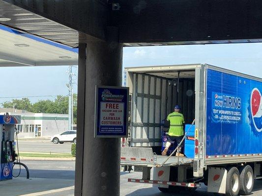 Pepsi delivery truck partially blocking the exit for the car wash