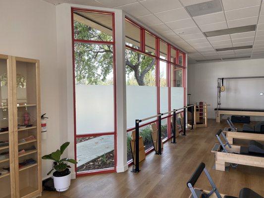 Main Pilates Studio with three reformers and ballet/fitness barre.