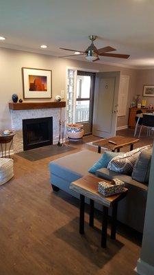 Mantel, fireplace, hearth, flooring, and tables