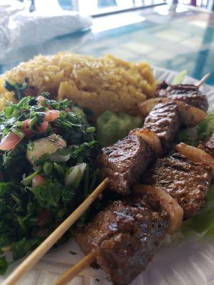 Beef kabob with tabouli and rice