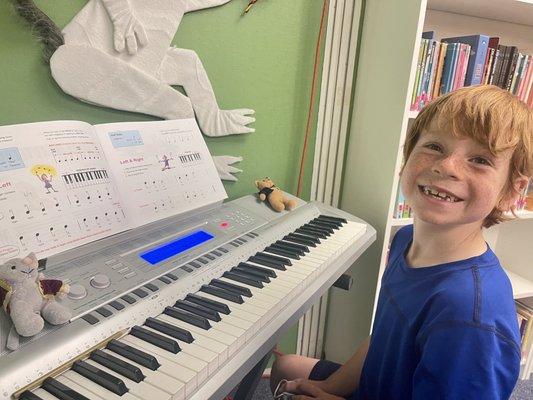 All smiles for his very first piano lesson.