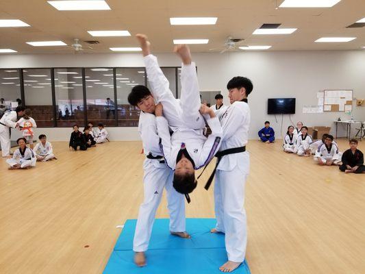 Back flip practice with members of the Yong-In University Demonstration Team