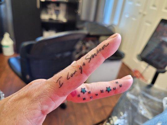 My fathers writing . Stars an heart on my other finger