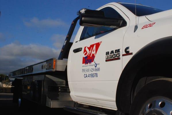 Tow truck services with customized logo.